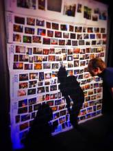 huge photo wall representing the usage of photo album maker for your travel memories