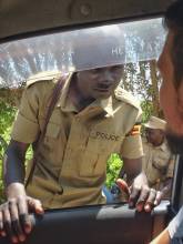 Friendly greeting a police officer on the border from Kenya to Uganda