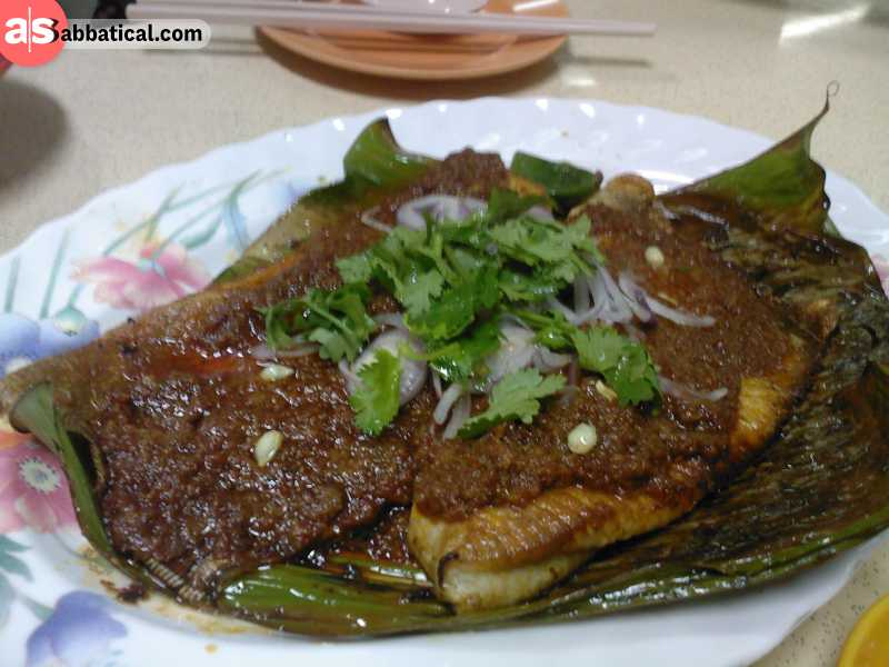 Barbecued stingray is wrapped and served in a banana leaf.