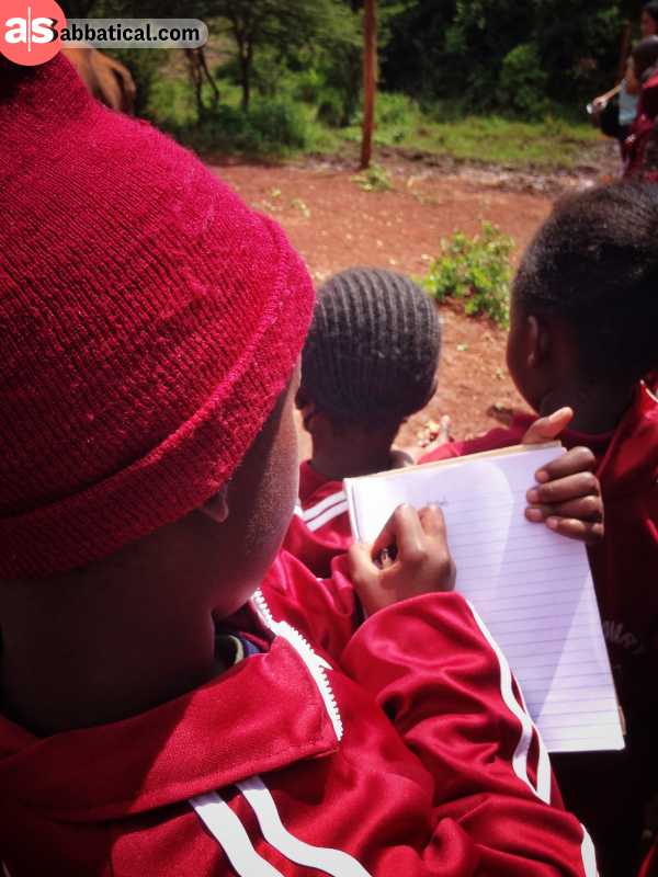 School boy in Kenya taking notes.