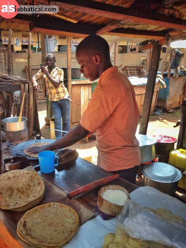 Eating street food (a rolex) on a market in Uganda