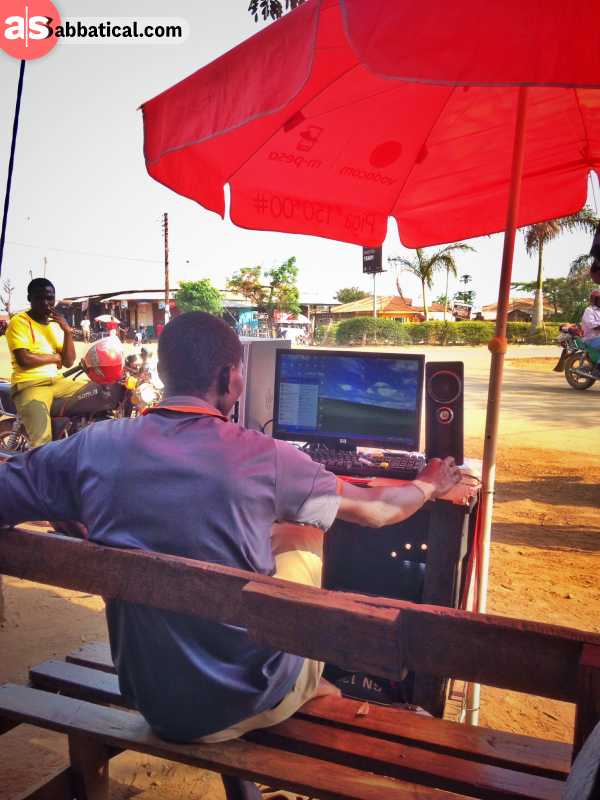 Person in Tanzania browsing the internet on an outdoor desktop computer