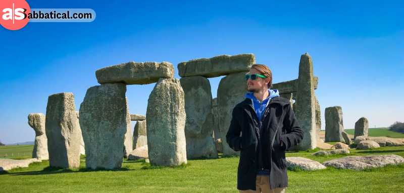 Adrian from aSabbatical standing in front of the stone circle of Stonehenge