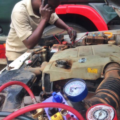 One of many bush mechanics trying to fix my car in Zambia